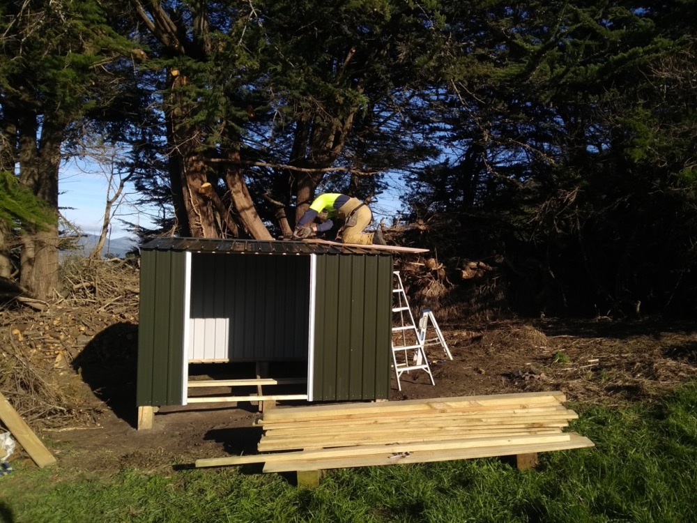 Securing the roof and preparing to lay the timber floor